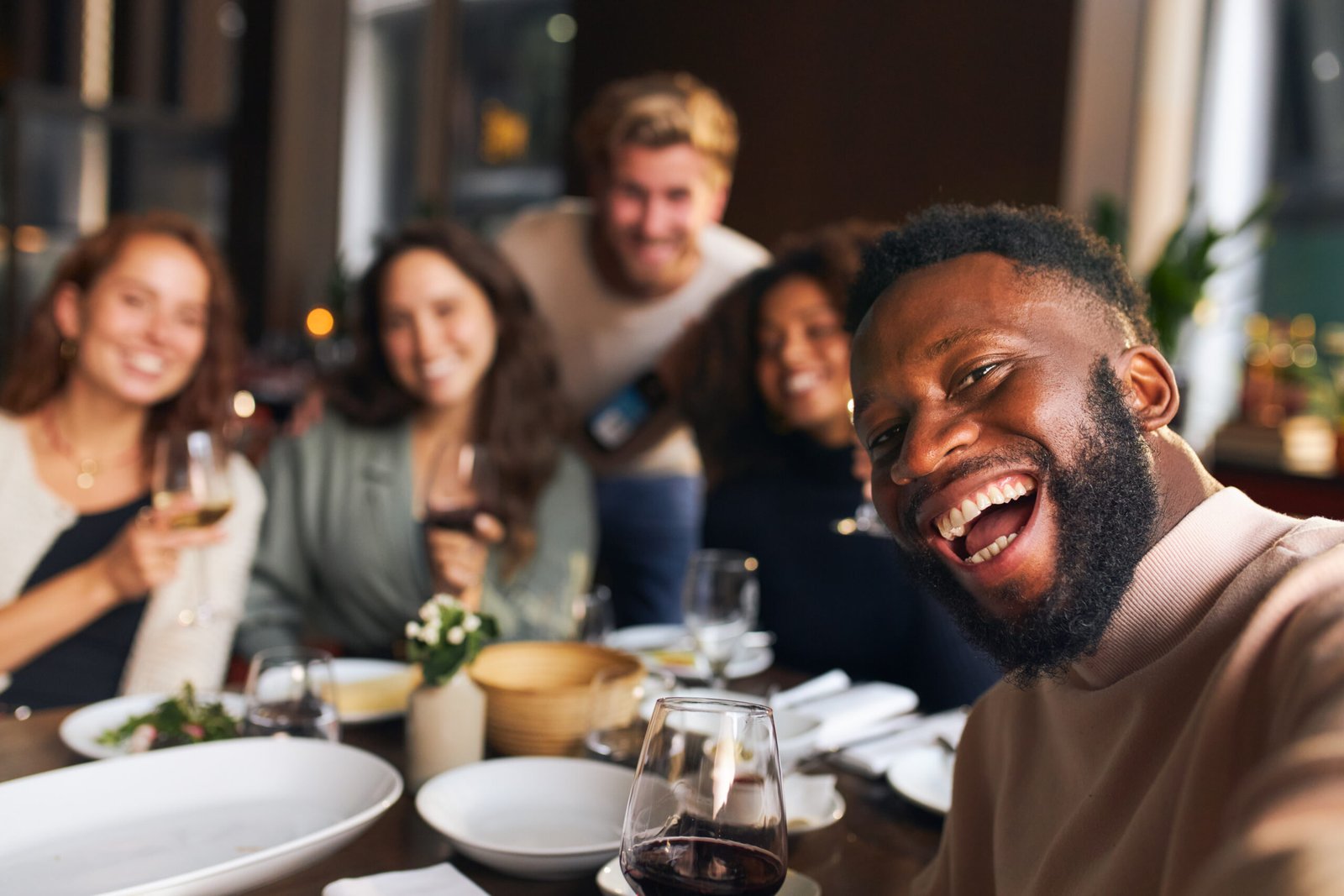 Friends taking group selfie in restaurant